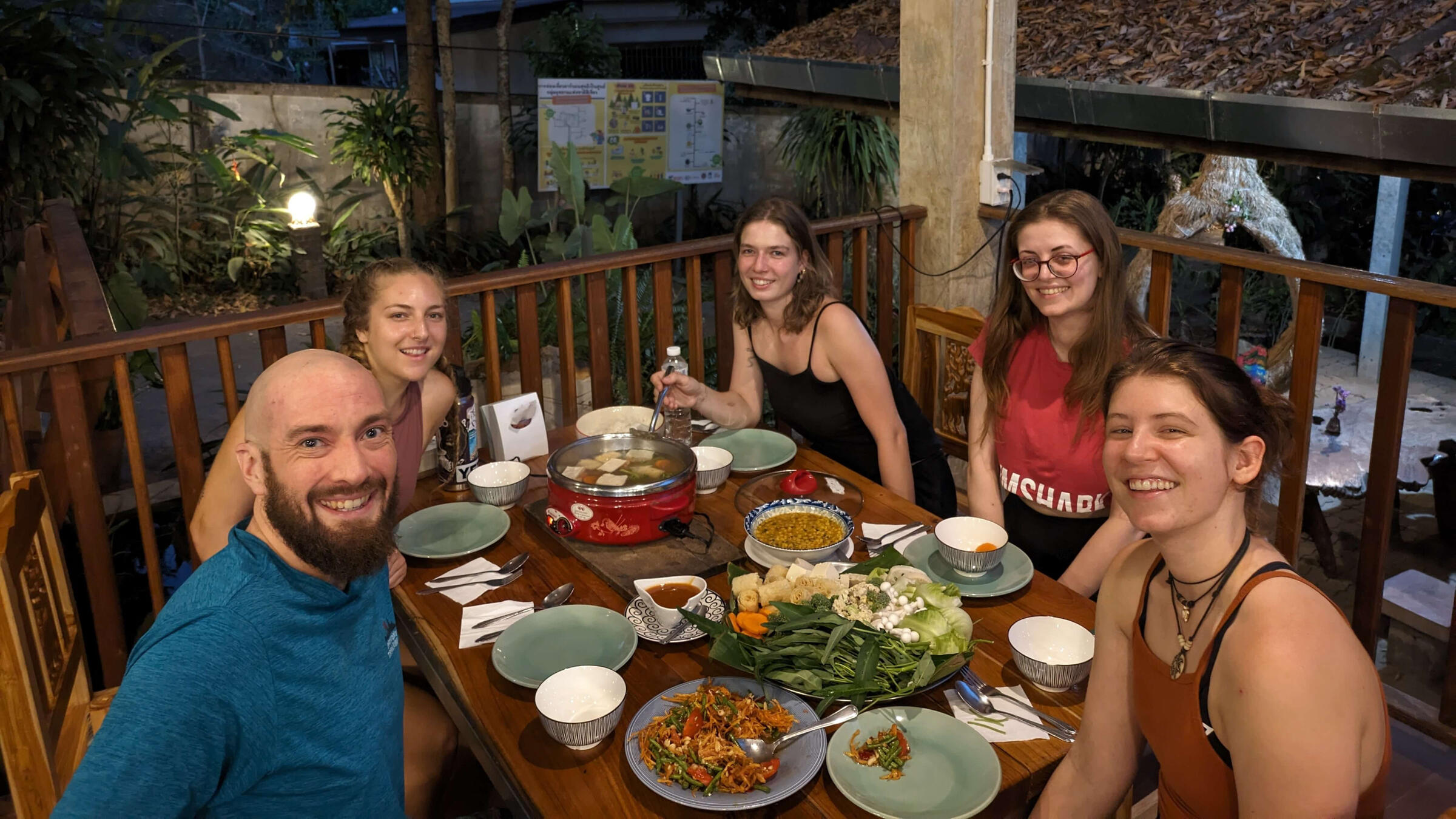 A group of people enjoying a traditional Thai hot pot at the Mae Win Guest Resort in Chiang Mai.